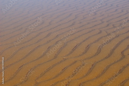 Submerged ripples in sand on a beach