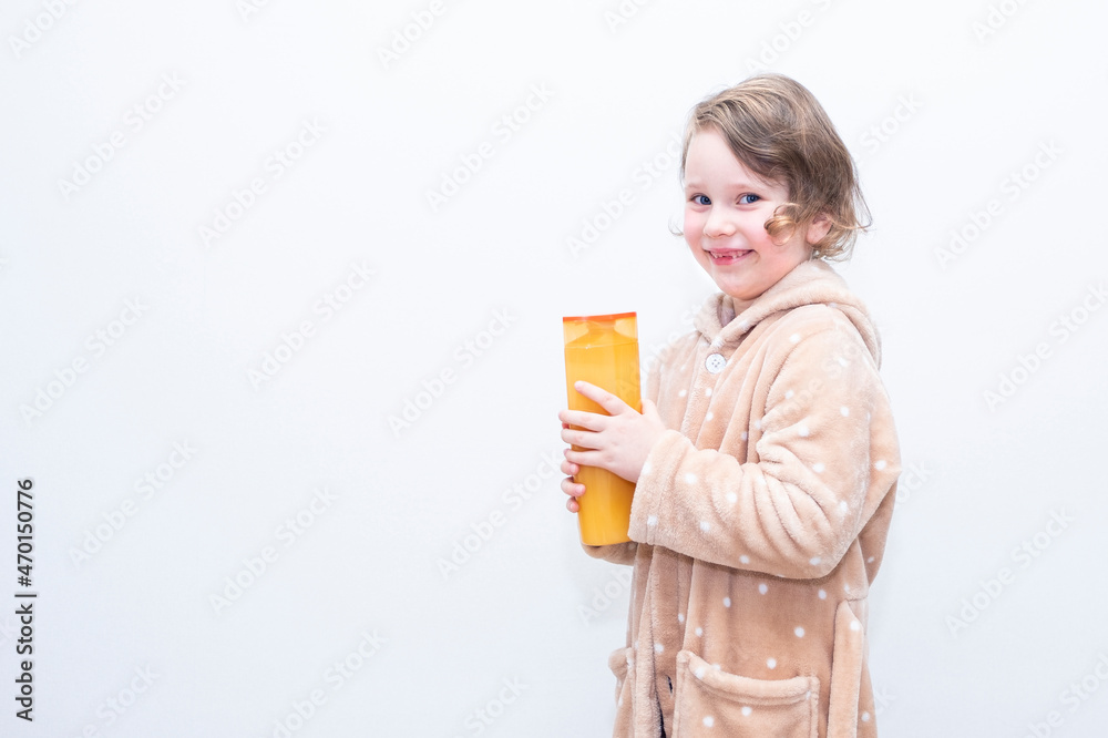 Child, Caucasian girl, with hair shampoo on the background of a gray wall. Copy space. Child, Caucasian girl, with hair shampoo on the background of a gray wall. Copy space.