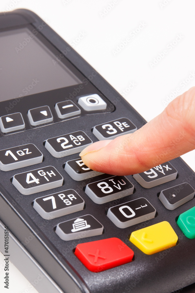 Payment terminal and finger entering PIN code. Credit card reader using for cashless paying Payment terminal and finger entering PIN code. Credit card reader using for cashless paying