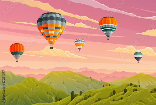 Clouds and striped hot air balloons against lilac cloudy sky fly over mountains. Hot air balloon festival. Beautiful sight several colored bright balls in the sunset sky. Romantic flight, travel
