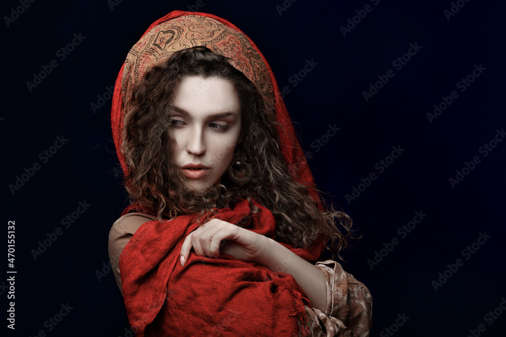 girl in a stylish oriental outfit. curly long hair girl in a stylish oriental outfit. curly long hair