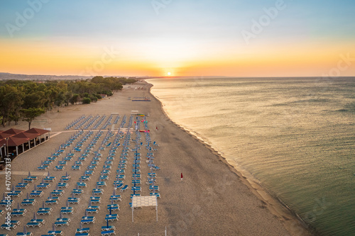 Aerial view of adriatic sea and sandy beach at sunrise, seascape and hill mountain on background, Simeri Mare, Calabria, Southern Italy