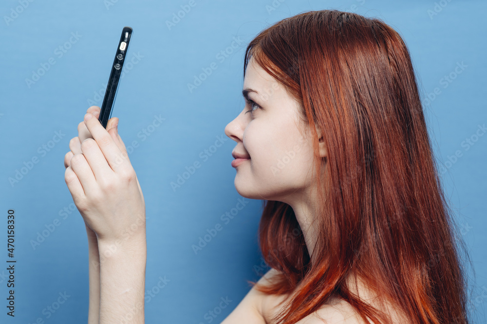 woman with red hair bare shoulders talking on the phone woman with red hair bare shoulders talking on the phone