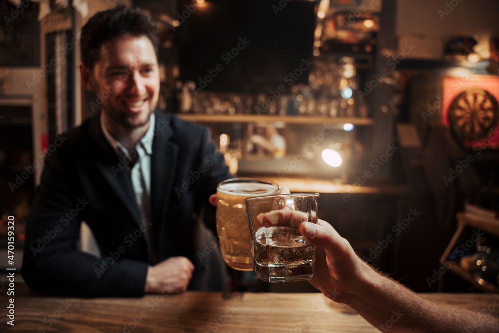 Caucasian customer sitting at bar having a drink with bartender 
