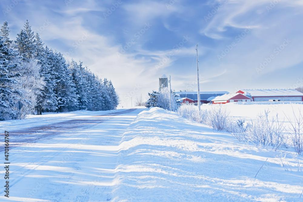 Snow covered road running through the farmland of rural Prince Edward Island, Canada. Snow covered road running through the farmland of rural Prince Edward Island, Canada.