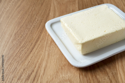 Wallpaper Mural Butter on white butter dish on wooden background, copy space. Made from cow milk. Torontodigital.ca