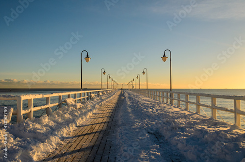 Snow covered pier in Gdynia Orlowo. Winter landscape, Baltic Sea, Poland.