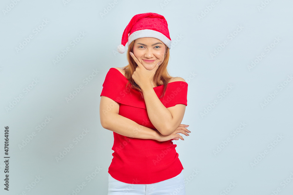 Portrait of young Asian woman wearing christmas dress smiling with finger on chin isolated on white background Portrait of young Asian woman wearing christmas dress smiling with finger on chin isolated on white background