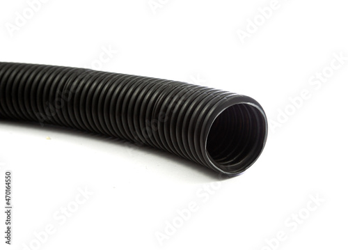 Black plastic corrugated pipe isolated on white background
