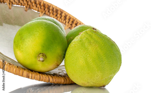 Several fragrant bergamots on a ceramic dish, close-up, isolated on white. photo