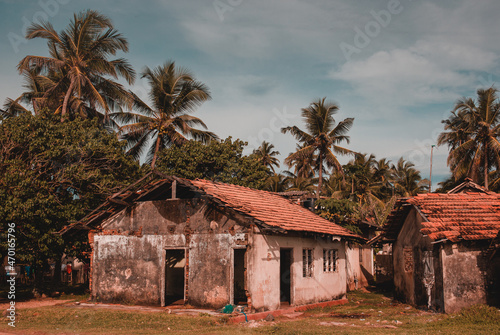 Old house on the beach side with palm trees in Sri Lanka