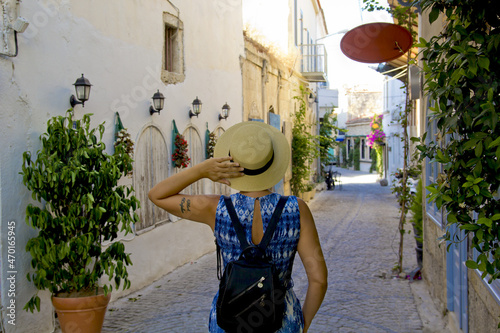 beautiful young woman in a hat in norrow street	 photo