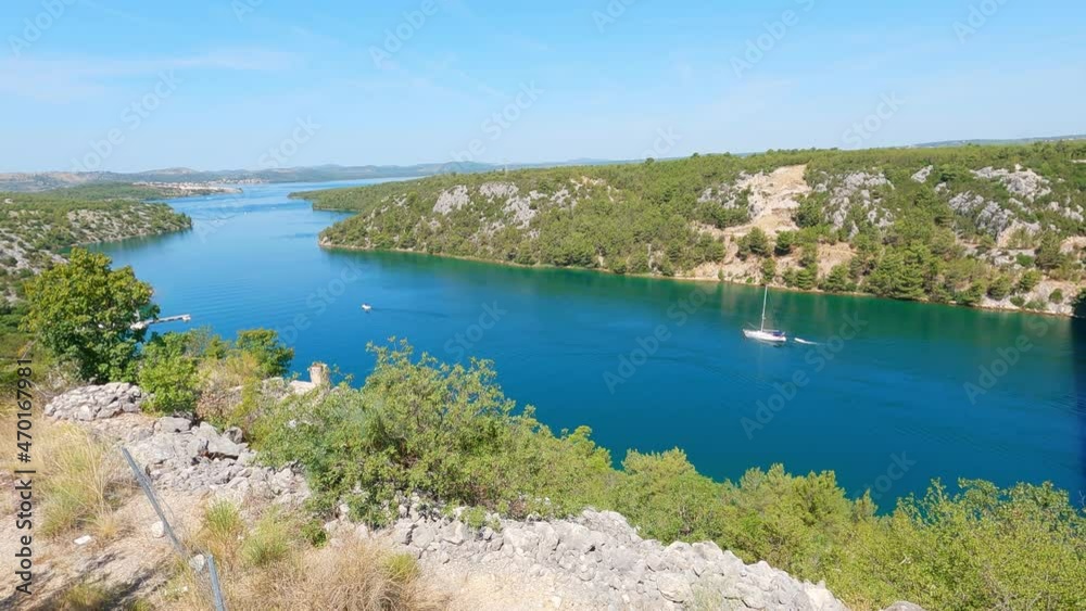 View of boats on Krka river, Croatia. Famous highway bridge over Krka river near city Skradin and Sibenik. Summer day. View of boats on Krka river, Croatia. Famous highway bridge over Krka river near city Skradin and Sibenik. Summer day.
