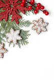 Christmas decoration. Christmas tree branches, red berries and snow flake shaped cookies on white background.