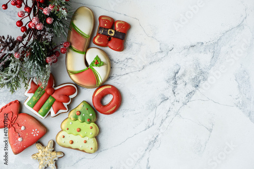 Flat lay of Christmas gingerbread cookies with festive icing and Christmas decoration on the white background. Merry Christmas and Happy New Year.