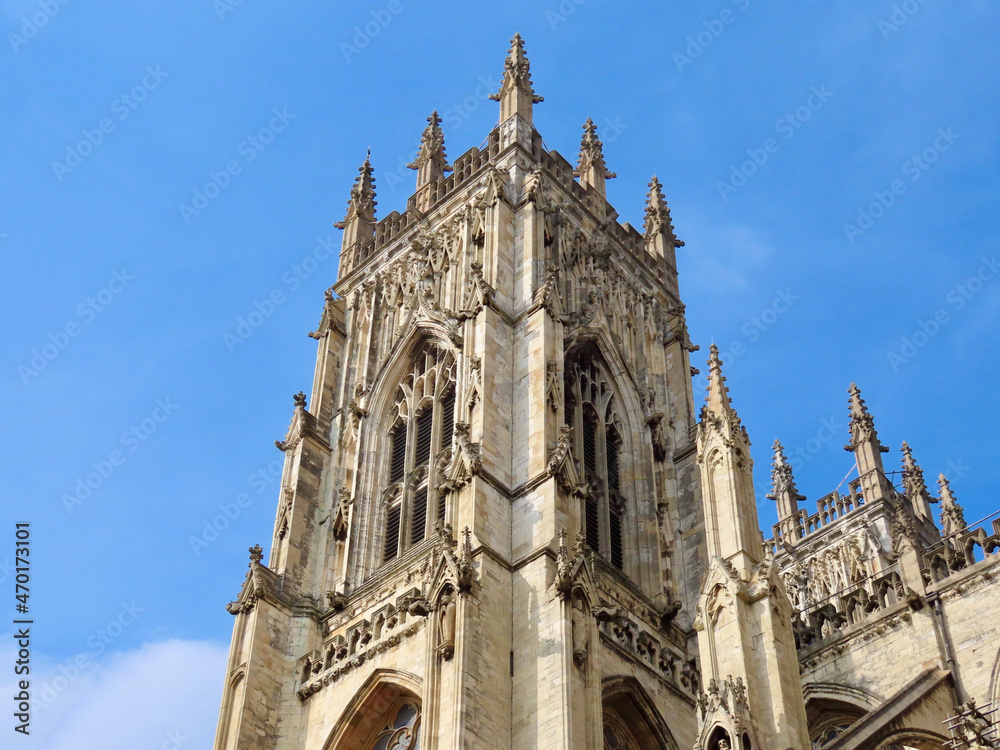 Central or West tower of York Minster cathedral, England, UK, on a sunny summer day with blue sky. Selective focus.