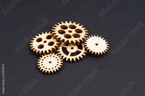 Gears lie on a black background. Close-up