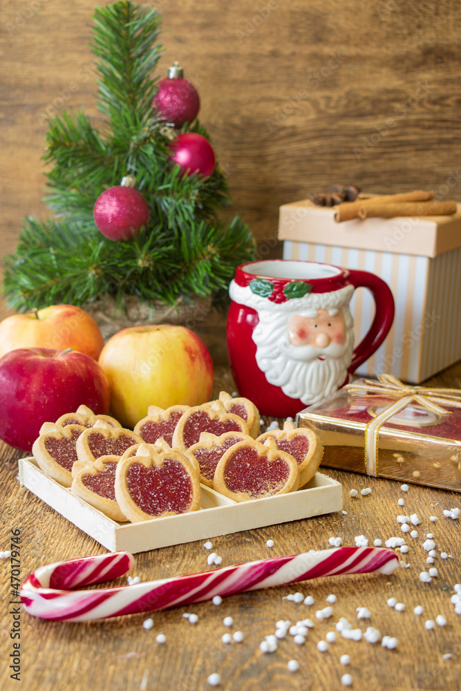 Apple cookies, apples and a red cup of black coffee near a wooden background. Dessert for breakfast. New Year's composition. Apple cookies, apples and a red cup of black coffee near a wooden background. Dessert for breakfast. New Year's composition.