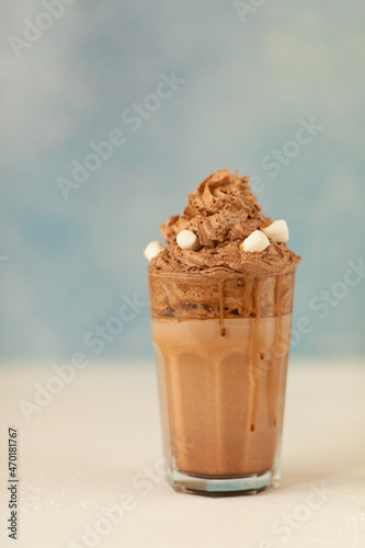 A chocolate cocktaile in glass with marshmallows on bokeh background photo