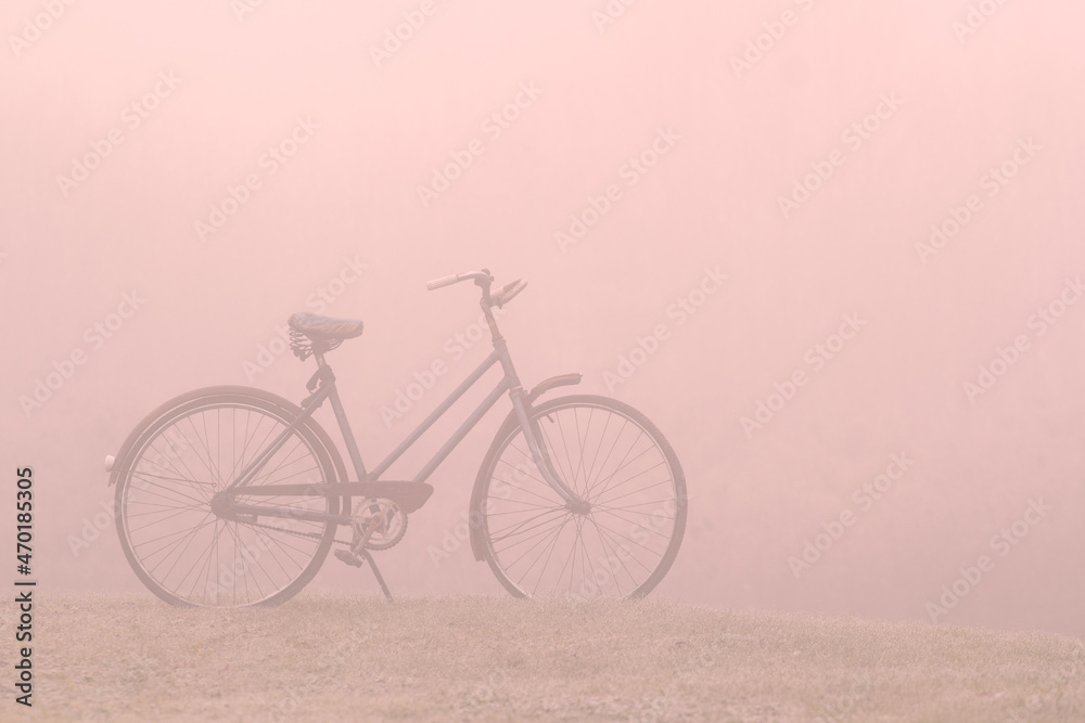 Old bicycle on a foggy morning