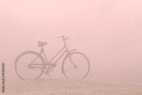 Old bicycle on a foggy morning