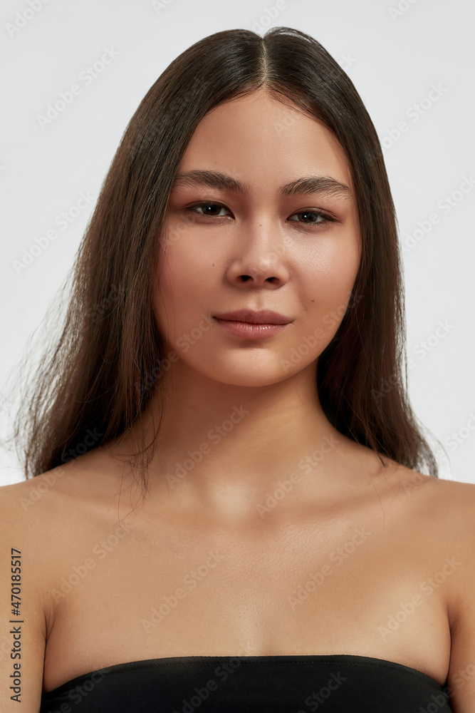 Vertical portrait of Asian woman with clean healthy face skin