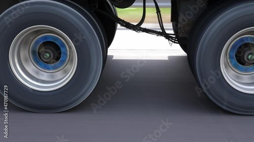 Passing commercial truck or lorry. Detail of wheels with blue hubs. Highway driving in Ontario, Canada. photo