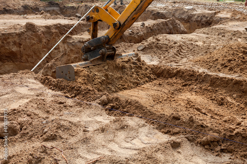 Excavator at work on the construction of a new home