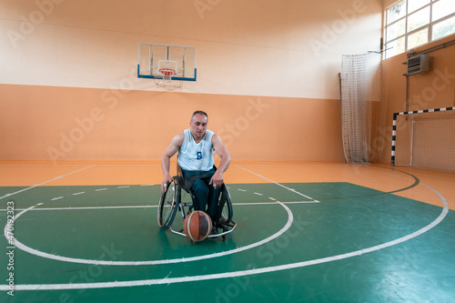 a photo of a war veteran playing basketball in a modern sports arena. The concept of sport for people with disabilities photo