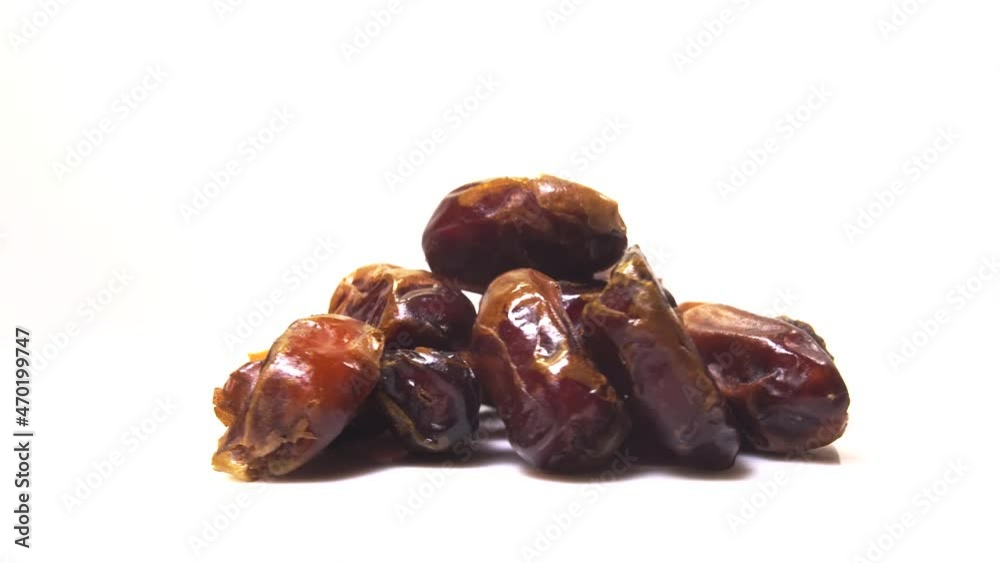 dried date fruit rotates on a white background around its axis.Arabic food dried date fruit rotates on a white background around its axis.Arabic food