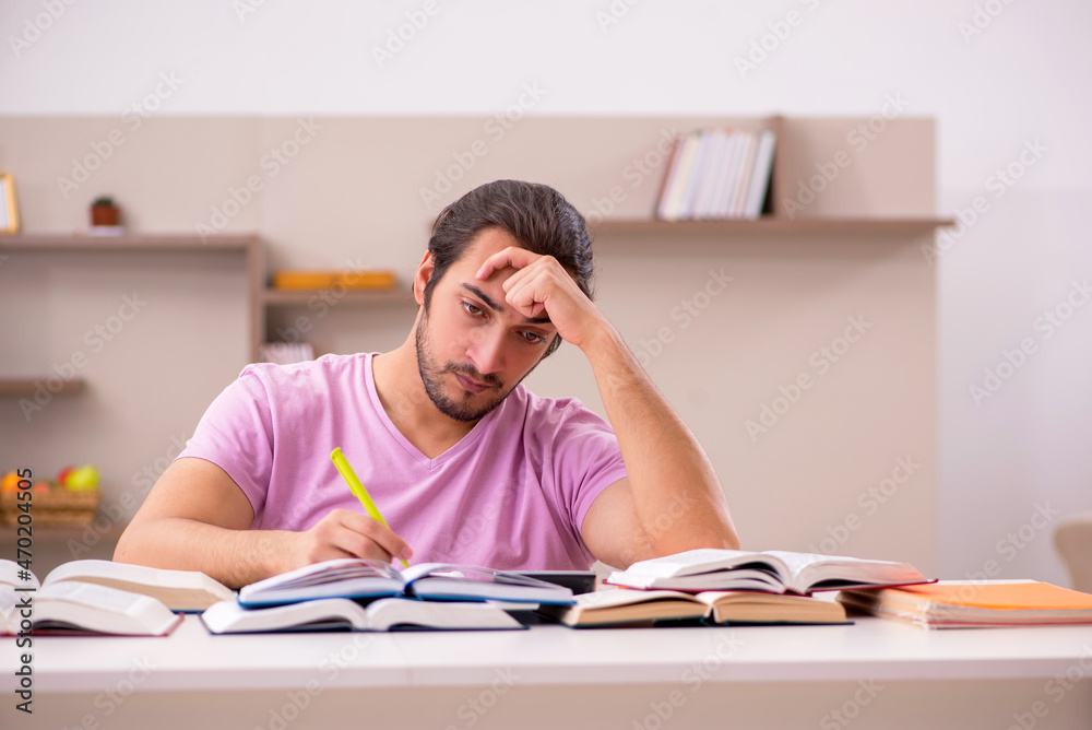 Young male student preparing for exams at home Young male student preparing for exams at home