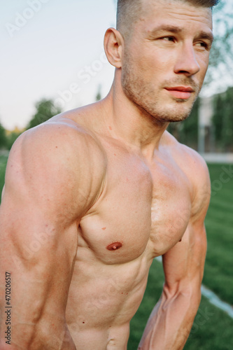 sporty muscled man with naked torso in a workout park © VICHIZH