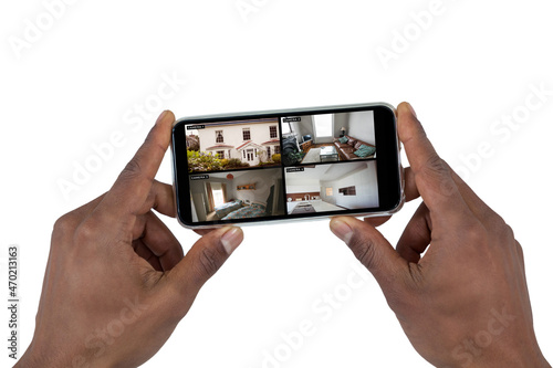 Hands of african american man holding smartphone with view of home from security cameras on screen