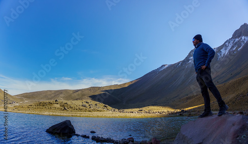 man and standing on top of the rock in nature. Travel concept photo