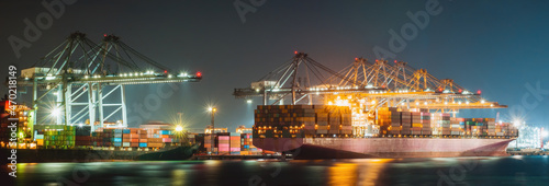 Wallpaper Mural Night light cargo ship and truck at seaport waiting for container dock crane  shipment harbor loading container import and export commercial trade business logistic and transportation international