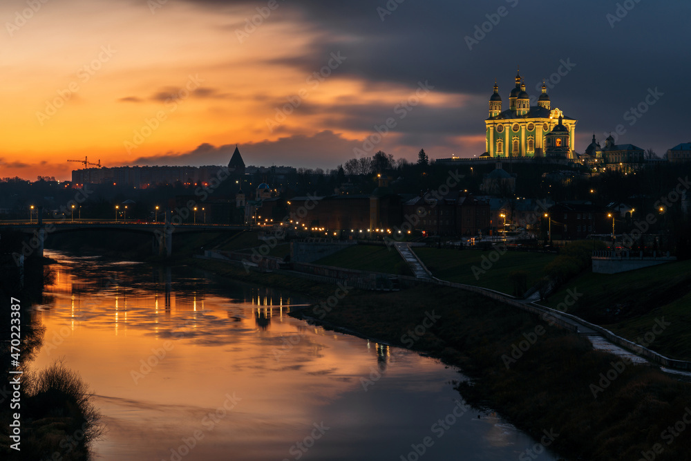 Fototapeta premium View of the embankment of the Dnieper River in Smolensk, the Assumption Cathedral and the wall of the Smolensk Fortress in the night illumination, Smolensk, Russia