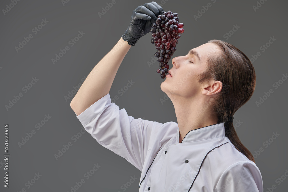 tasting delicious grapes