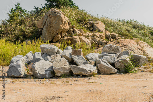 Large granite and sandstone boulders on hillside