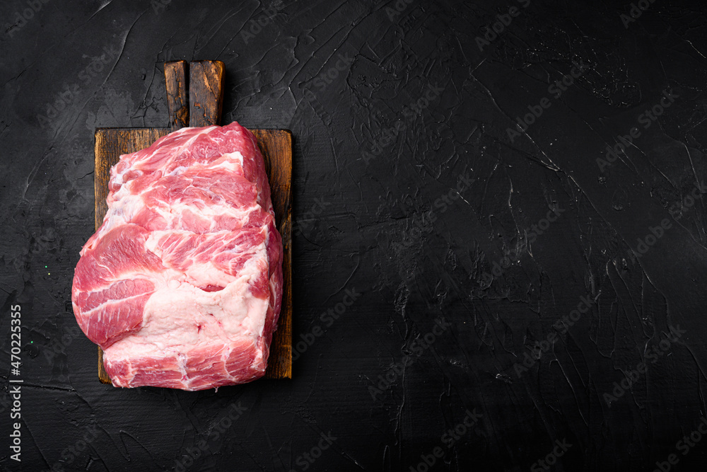Raw meat, on black dark stone table background, top view flat lay, with copy space for text