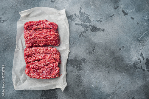 Organic Raw Grass Fed Ground Beef, on gray background, top view flat lay  with copy space for text photo