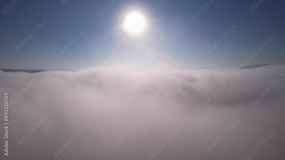 moving forward to Sun is rising above the morning mists fog of clouds over the tree-covered mountain slopes at sunrise. Amazing nature landscape, 4K drone in sky moving forward to Sun is rising above the morning mists fog of clouds over the tree-covered mountain slopes at sunrise. Amazing nature landscape, 4K drone in sky