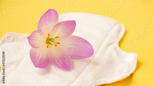 washable sanitary napkins bamboo charcoal pads on yellow background with crocus flower. Sanitary pad for healthy women  reusable menstrual pad. Health care  zero waste  ecological concept.