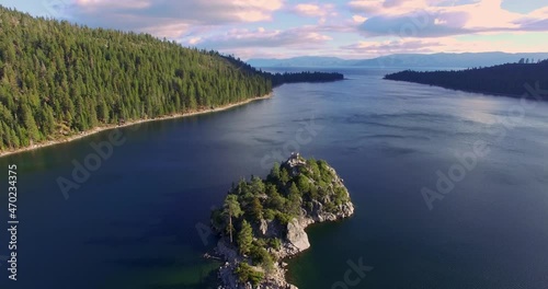 Aerial over shoreline and trees at Lake Tahoe emerald bay