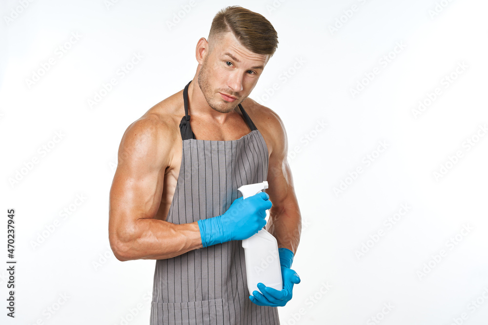 sporty muscular man wearing an apron detergent cleaning