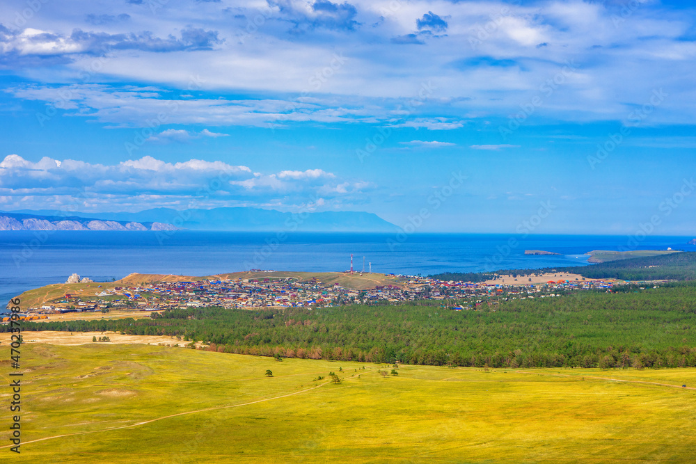 View from hill to Khuzhir village of Olkhon island and Maloe More bay of lake Baikal, Russia. Picturesque summer landscape, beautiful background. Discovering distant places of Earth, travel concept