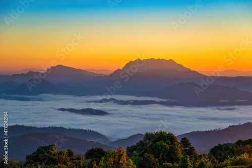 Tropical forest nature landscape view with mountain range sunrise with moving cloud mist at Huai Nam Dang National Park, Chiang Mai Thailand