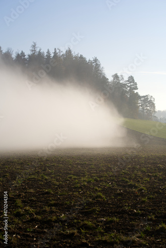 Scenic panorama landscape with waft of mist and freshly harvested field on a sunny autumn day. Photo taken November 12th, 2021, Zurich, Switzerland.