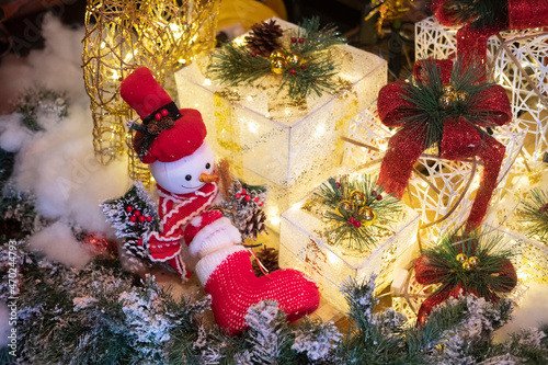 snowman toy in Santa Claus costume with decorated gift box