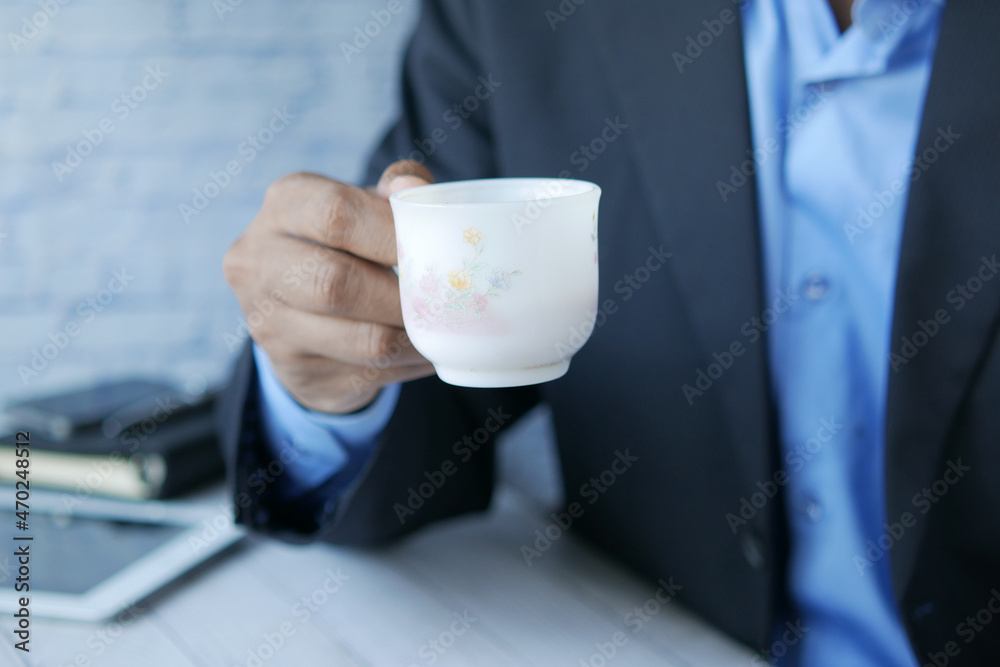 businessman drinking tea while sited businessman drinking tea while sited