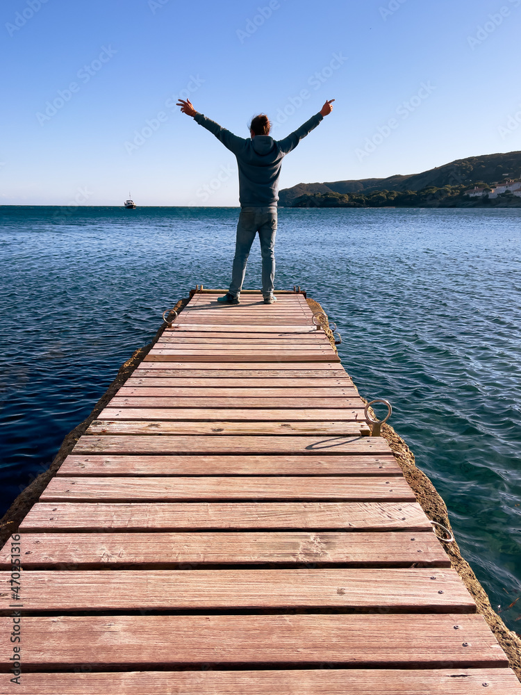 happy man on wooden bridge on the sea